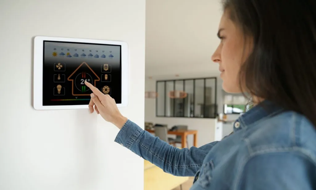 Woman using smart wall home co 1